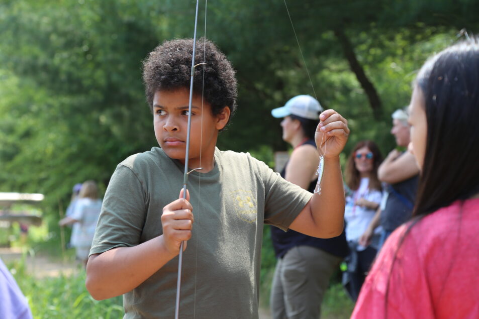 boy holds fishing pole