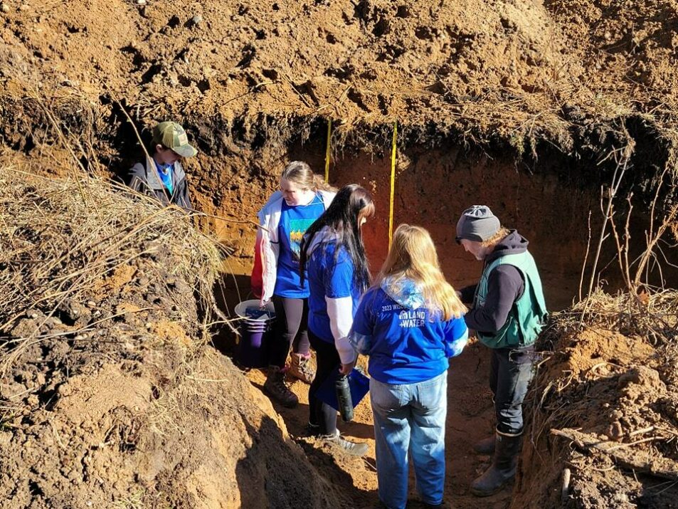 people gathered in soil pit