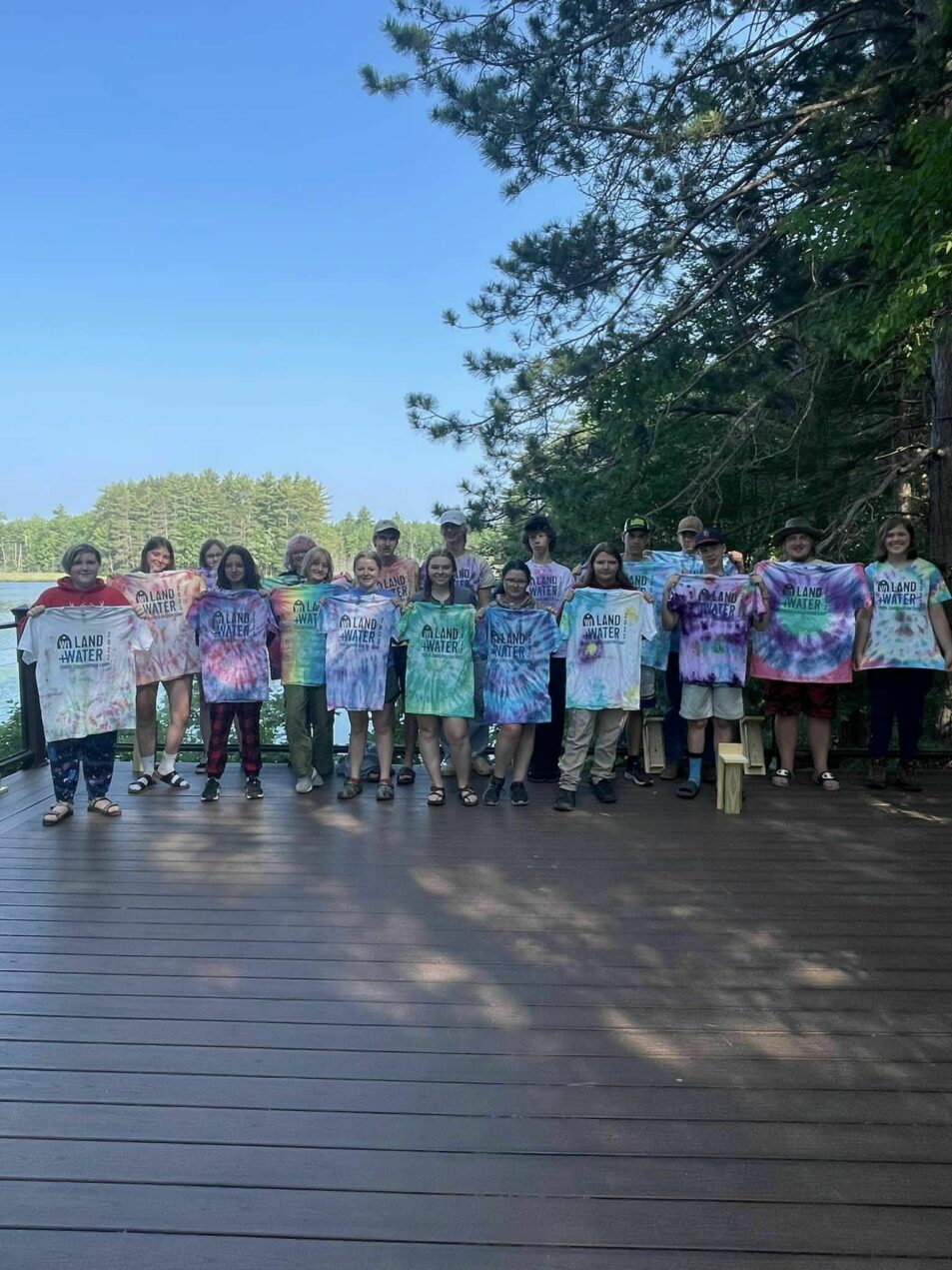 campers holding tie-dyed shirt