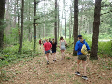 Campers walking through forest
